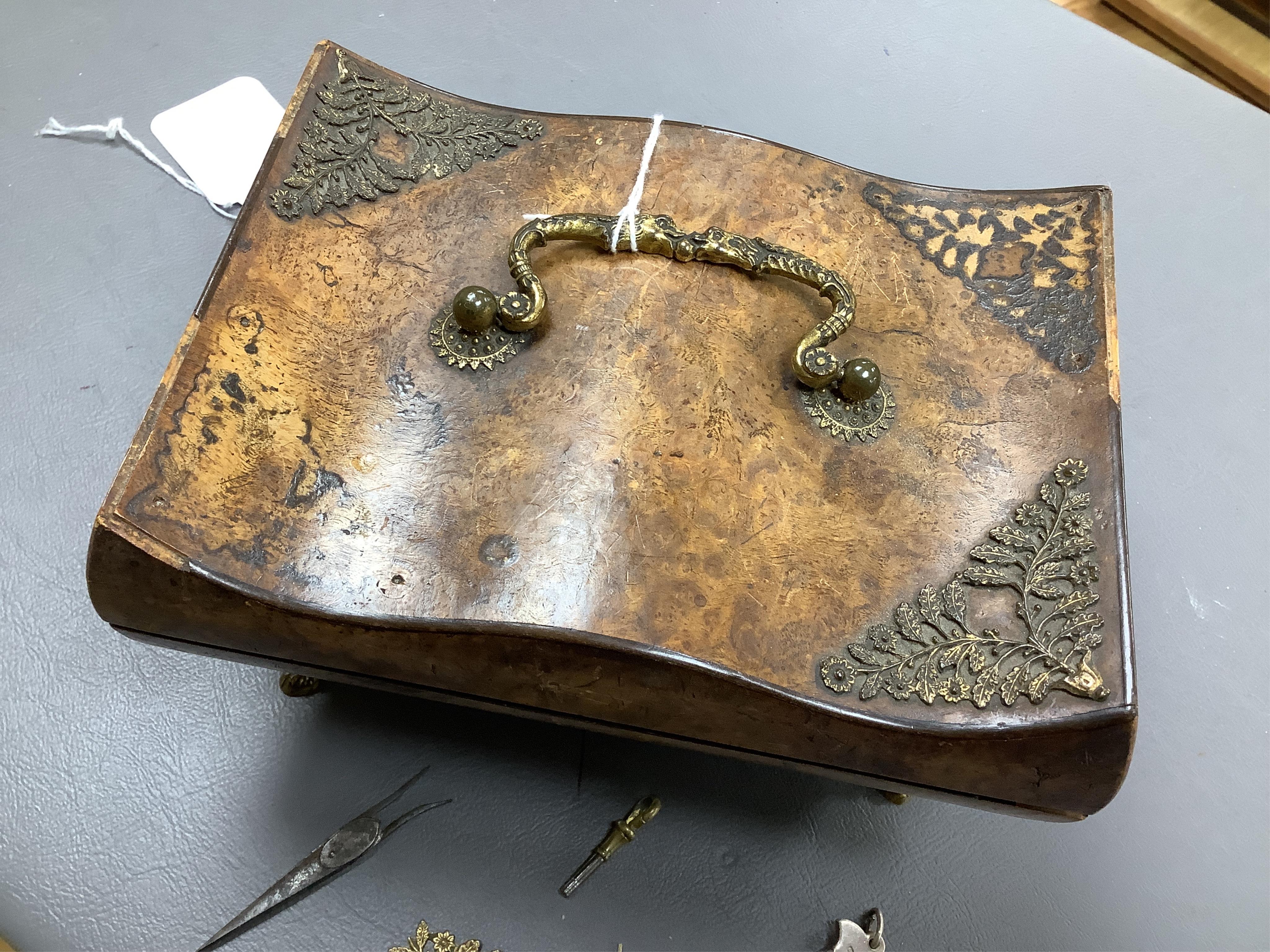 A 19th century burr walnut musical sewing box with mirrored and fitted interior and two silver keys, 18cm wide (mirror cracked)